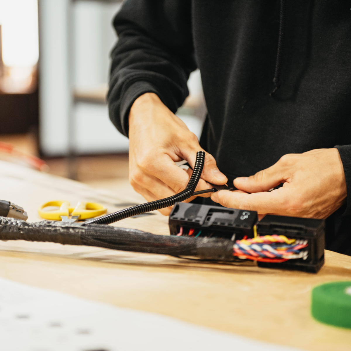 Close up of a person building a build board for product testing.